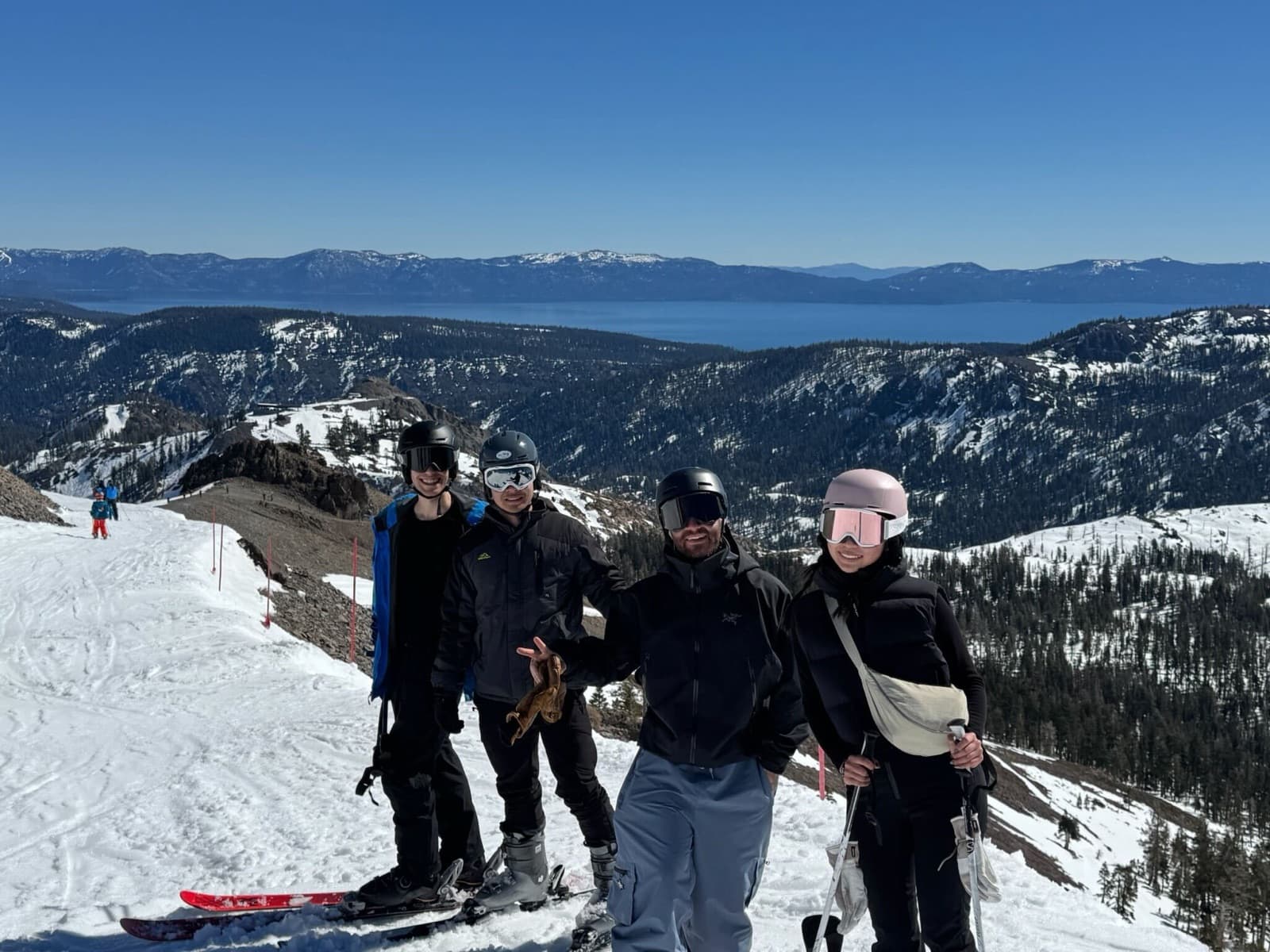 Four Replo teammates at a mountain summit above Lake Tahoe