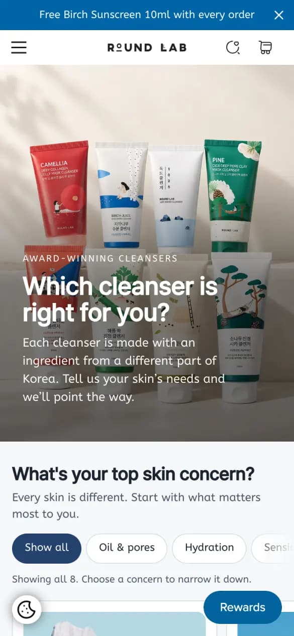 Round Lab's cleanser finder on a phone: “Which cleanser is right for you?” over five cleanser tubes, then skin-concern buttons