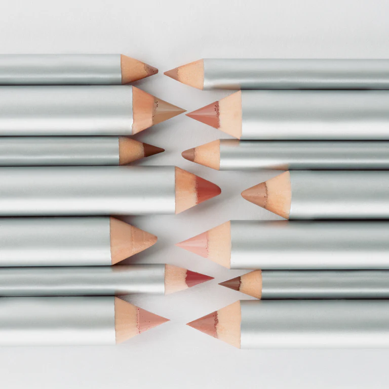 Two rows of makeup pencils stacked together on a white background